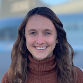 Headshot of Ellen Beilsmith, a white woman wearing a red turtleneck